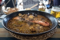 Traditional paella with rabbit, sausage, clam, mussel, and prawns